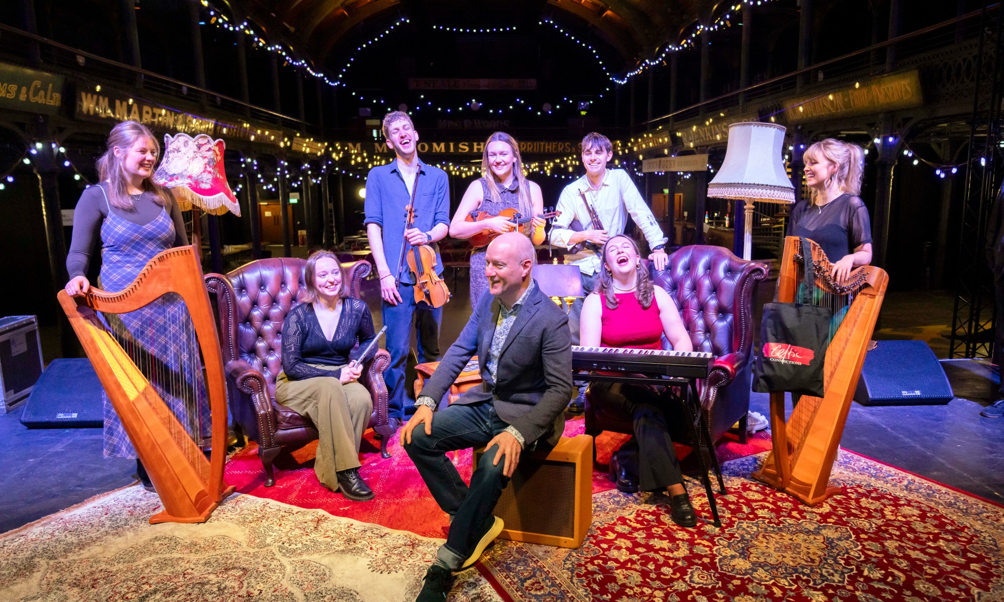 Donald Shaw and artists pose on stage at Fruitmarket in Glasgow