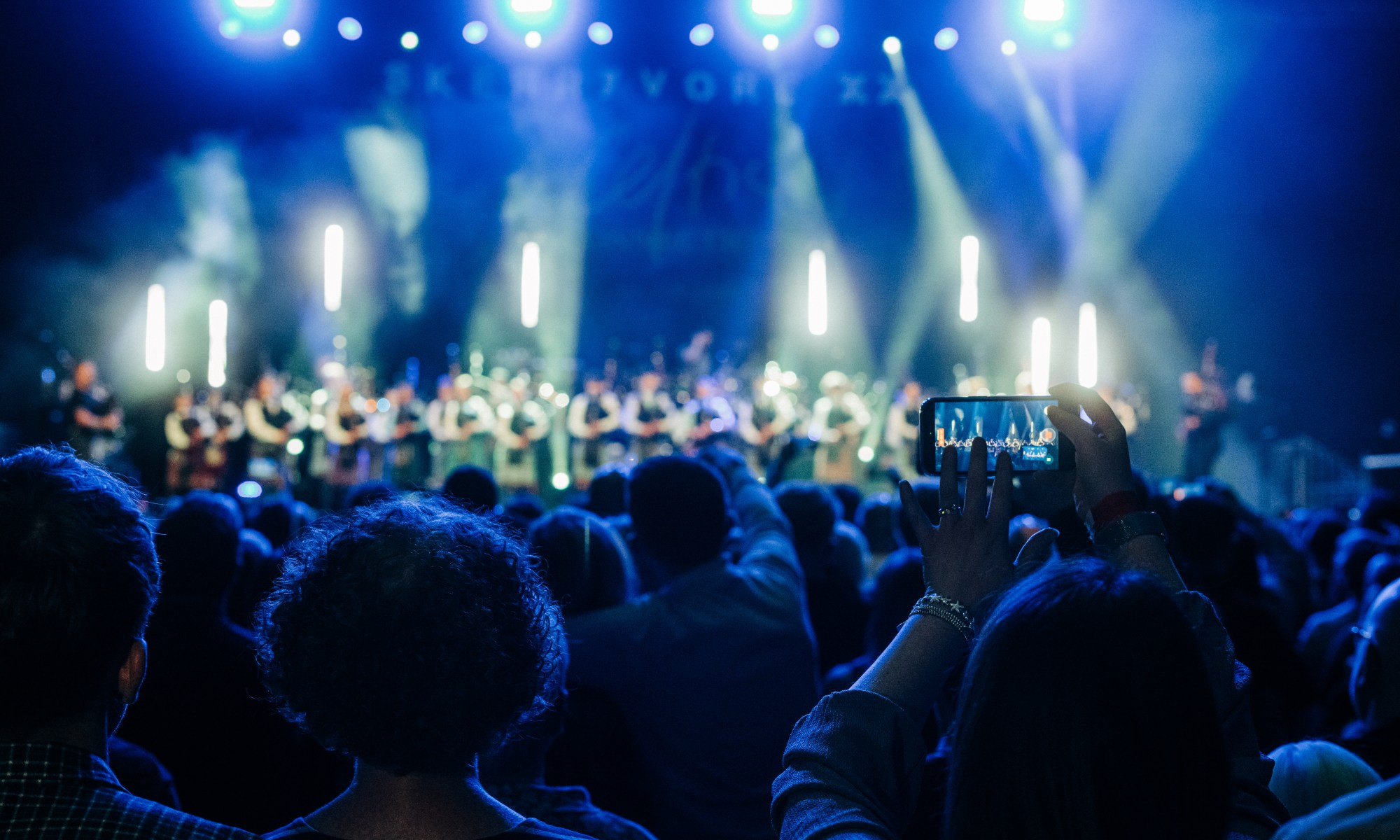 Skerryvore on stage at Emirates Arena with large crowd in front