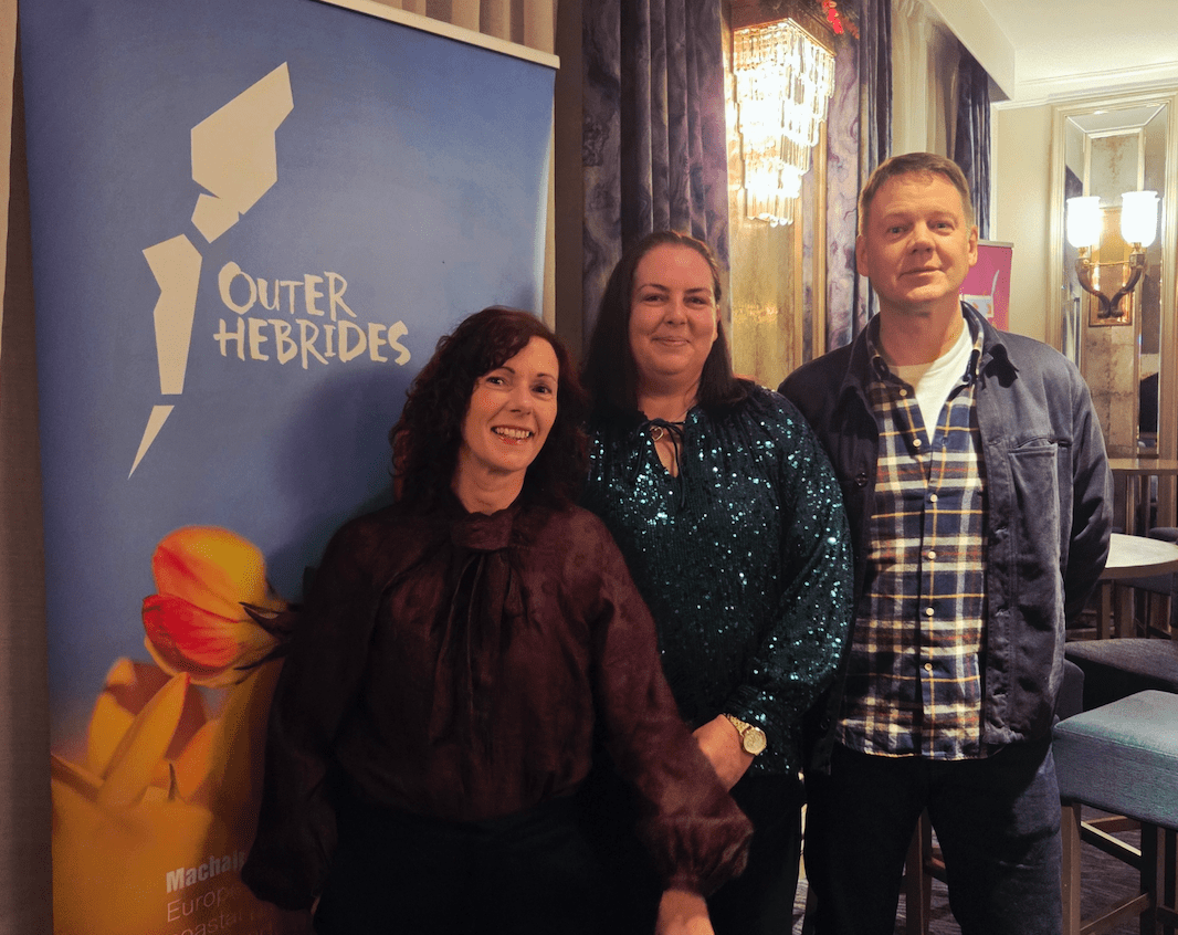 Jane Morrison - Director _ Volunteer Coordinator, Carol Ferguson - Operations Co-Ordinator, Coinneach Morrison - Director _ Bars and Catering Manager in front of awards sign