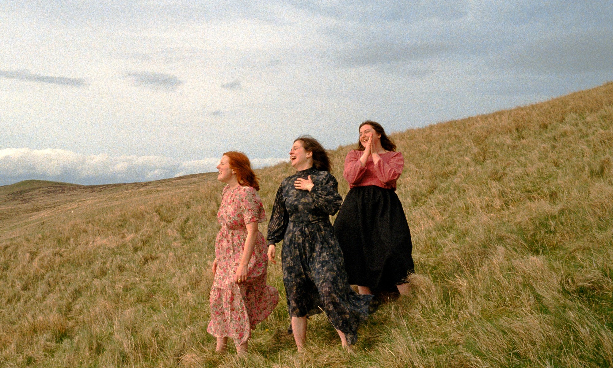 Sian members in a filed looking into distance